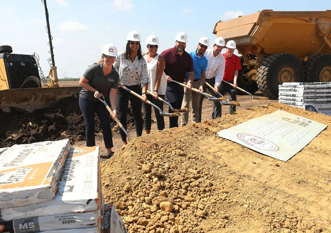 Grow Clinton board members with shovels at the Atlas Roofing groundbreaking